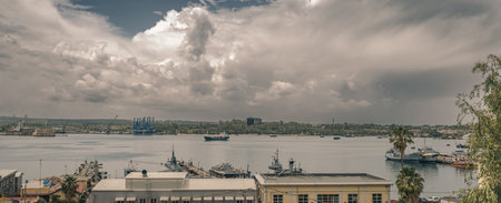Stormy clouds over the military and commercial port of Augusta, Syracuse province, Sicily, Italyの写真素材