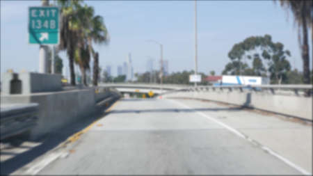 Driving on intercity freeway in Los Angeles, California USA. Defocused view from car thru glass...
