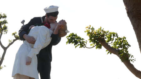 SAN DIEGO, CALIFORNIA USA - 23 FEB 2020: Unconditional Surrender Statue, USS Midway Museum. Symbol of navy fleet and Victory over Japan Day. Sailor kissing a woman, World War II memorial sculpture.のeditorial素材