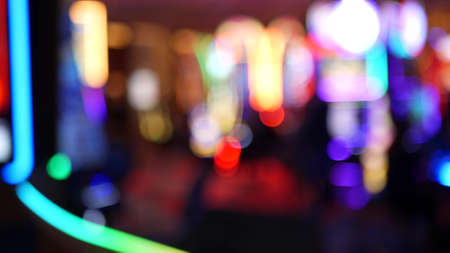 Defocused slot machines glow in casino on fabulous Las Vegas Strip, USA. Blurred gambling jackpot...