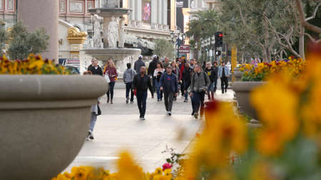 LAS VEGAS, NEVADA USA - 13 DEC 2019: People on pedestrian walkway. Multicultural men and women...
