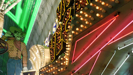LAS VEGAS, NEVADA USA - 12 DEC 2019: Cowboy Vegas Vic, old neon sign glowing, Freemont street in sin city. Illuminated retro welcoming signboard to Pioneer Club casino. Vintage greeting man at night.のeditorial素材