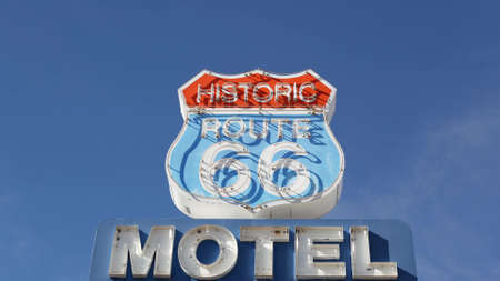 Motel retro sign on historic route 66 famous travel destination, vintage symbol of road trip in USA. Iconic lodging signboard in Arizona desert. Old-fashioned neon signage. Classic tourist landmark.のeditorial素材