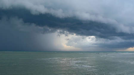 Waving blue sea, sandy shore of Samui Island during wet rain season, Thailand. Hurricane and storm...