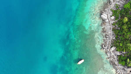 Calm colorful azure turquoise sea near tiny tropical volcanic island Koh Tao, unique small paradise...