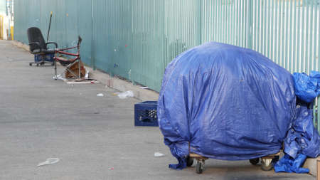SAN DIEGO, CALIFORNIA USA - 4 JAN 2020: Stuff of homeless street people on walkway, truck on roadside. Begging problem in downtown of city near Los Angeles. Jobless beggars live on pavements.のeditorial素材