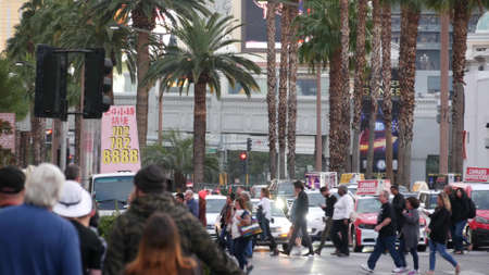 LAS VEGAS, NEVADA USA - 13 DEC 2019: People on pedestrian walkway. Multicultural men and women walking on city promenade. Crowd of citizens on sidewalk. Diversity of multiracial faces in metropolis.のeditorial素材