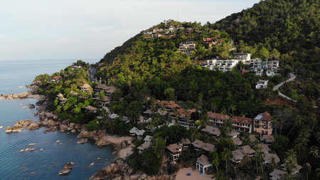 Villas on green mountain ridge. Majestic drone view of luxury villas located on green mountain range...