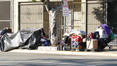 SAN DIEGO, CALIFORNIA USA - 4 JAN 2020: Stuff of homeless street people on walkway, truck on...