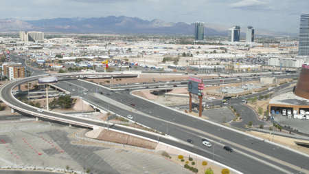 LAS VEGAS, NEVADA USA - 7 MAR 2020: Sin city in Mojave desert from above. Traffic highway in valley with arid climate. Aerial view of road in tourist metropolis. Gambling and betting area with casino.のeditorial素材