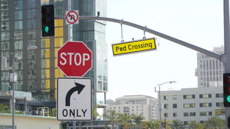 Traffic light and caution sign, road intersection in USA. Transportation safety, rules and...