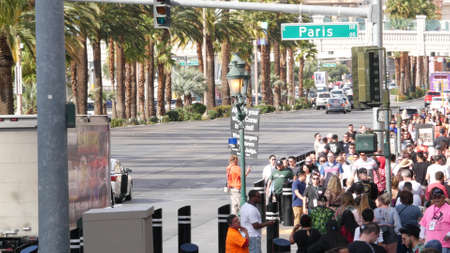LAS VEGAS, NEVADA USA - 7 MAR 2020: People on pedestrian walkway. Multicultural men and women...