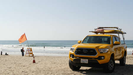 Oceanside, California USA - 8 Feb 2020: Yellow lifeguard car, beach near Los Angeles. Coastline...
