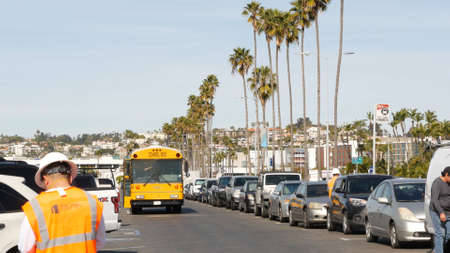 San Diego, California USA - Jan 31, 2020: American yellow school bus, street in downtown. Schoolbus shuttle on road, city near Los Angeles. Education transportation infrastructure.のeditorial素材