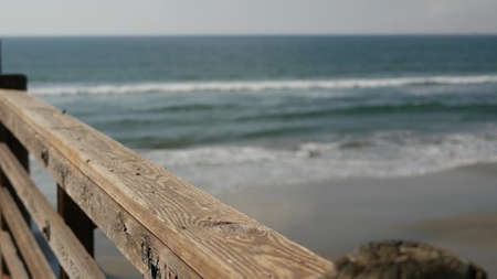 Railings of old wooden pier, waterfront boardwalk, Oceanside beach atmosphere, California coast USA....