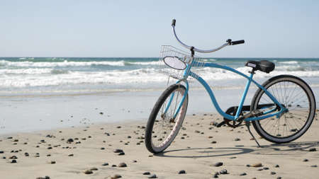 Blue bicycle, cruiser bike by ocean beach pacific coast, Oceanside California USA. Summertime...