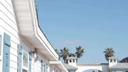 San Diego, California USA - 25 Nov 2020: Wooden Crystal pier and white blue cottages on ocean beach. Vacations beachfront houses on Mission beach. White homes or waterfront bungalows on sea coast.のeditorial素材