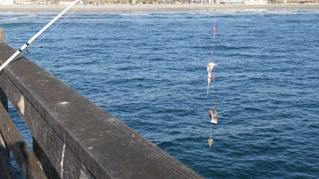 Saltwater angling, wooden pier boardwalk, fishing accessory, tackle or gear. Oceanside California...
