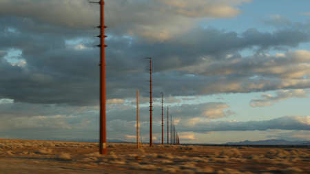 Road trip, driving auto from Death Valley to Las Vegas, Nevada USA. Hitchhiking traveling in America. Highway journey, dramatic atmosphere, sunset mountain and Mojave desert wilderness. View from car.の写真素材