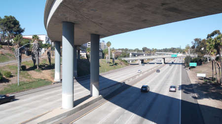 Multiple lane highway interchange or intersection, freeway overpass bridge. Cars traffic on road, California transportation infrastructure, San Diego, USA. Crossroad junction in city near Los Angeles.の写真素材