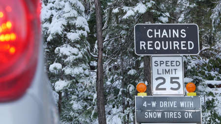 Chains or snow tires required traffic sign, mountains winter highway, Yosemite snowy forest,...