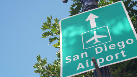 Airport green road sign with direction arrow and plane icon, San Diego city street, California USA. Tourist destination, traffic signage. Local and international traveling concept.の写真素材