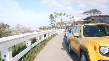 Waterfront or beachfront promenade with palmtrees. Yellow car and palm trees, Rocky Point in La...