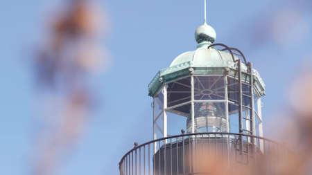 Vintage lighthouse tower, retro light house, old fashioned historic classic beacon, fresnel lens. Nautical navigational coastal building 1855. San Diego, California USA. Seamless looped cinemagraph.の写真素材