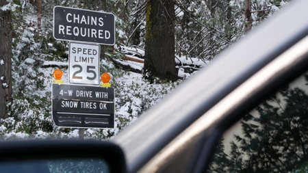 Chains or snow tires required traffic sign, mountains winter highway, Yosemite snowy forest,...