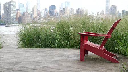 New York City waterfront skyline, Manhattan Midtown buildings, riverfront skyscrapers by East river water. Waterside cityscape view, Gantry Plaza Park, Long Island, Queens. United States. Chair bench.の写真素材