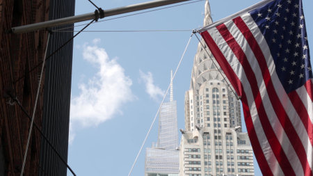 New York, american flag waving. Chrysler building. Manhattan midtown 42 street, city architecture....