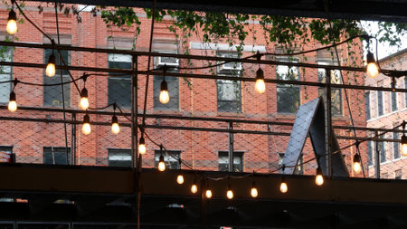 New York City classic building architecture. Urban residential house exterior. Real estate property in USA. Typical red brick facade. High line end in Chelsea, Meatpacking district. Light bulb garlandの写真素材