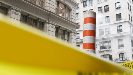 Steam vapor vented on New York City street, orange vapour tube stack. Hot smoke from pipe. Con...
