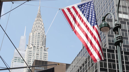 New York, american flag waving. Chrysler building. Manhattan midtown 42 street, city architecture....