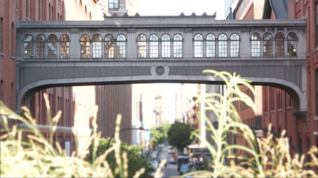 New York City street, Chelsea Market skybridge. Retro industrial architecture, red brick building....