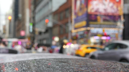 New York City Times Square, Manhattan Midtown Broadway street, USA. American NYC urban life. Wet road on autumn rainy day, traffic defocused. People pedestrians, Yellow taxi cab. Commercial billboardsの写真素材