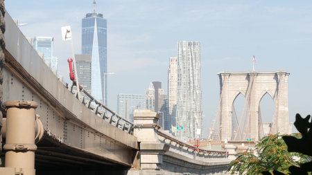 Brooklyn Bridge to Manhattan downtown. New York City skyline, financial district cityscape. World...