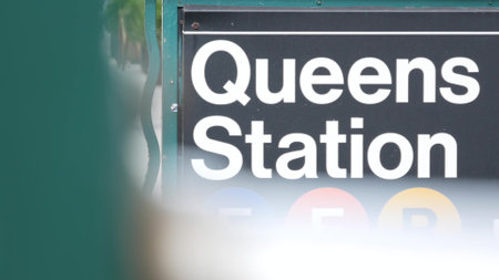 New York subway sign, Queens underground metro station. Metropolitan entrance fence, public transport exit. Long Island city street, NYC United States. Navigation text on signboard. Passenger guidanceの写真素材