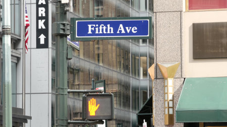 Fifth avenue, 5 ave road sign, Manhattan midtown architecture, New York City 5th av street corner. Traffic crossroad signage, USA. Parking garage and american flag.の写真素材