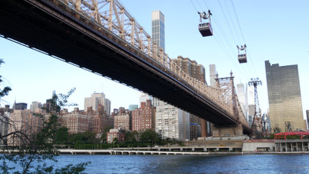 New York City Roosevelt Island tramway to Manhattan Midtown streets. American cable tram near...