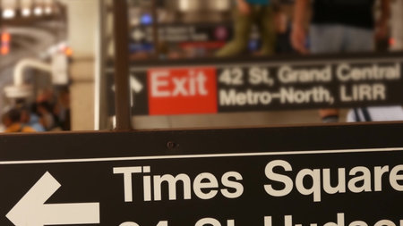 New York subway station interior, underground metropolitan platform. United States public metro transportation. Passenger railway traffic. Text sign: Times Square, Grand Central, 42. People and train.の写真素材