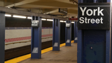 New York City empty subway station interior, underground metropolitan platform sign. Inside metro, railway passenger public transport, United States. Text signboard: York Street. Brooklyn Downtown NYCの写真素材
