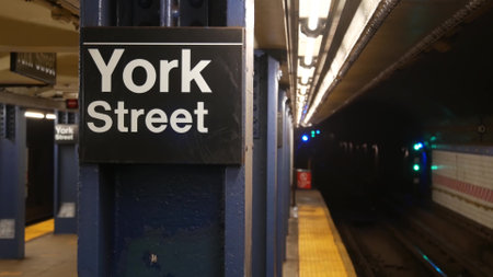 New York City empty subway station interior, underground metropolitan platform sign. Inside metro, railway passenger public transport, United States. Text signboard: York Street. Brooklyn Downtown NYCの写真素材
