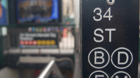 New York City subway sign, underground metro station. Metropolitan entrance green fence, Manhattan public transport exit. Pedestrians people. 34 street, Penn Station, United States passenger railroad.の写真素材