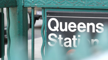 New York subway sign, Queens underground metro station. Metropolitan entrance fence, public transport exit. Long Island city street, NYC United States. Navigation text on signboard. Passenger guidanceの写真素材