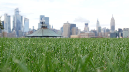 New York City waterfront skyline, Manhattan Midtown Hudson Yards buildings, riverfront skyscrapers. Waterside cityscape from Pier A Park, Hoboken, New Jersey. United States architecture, grass lawn.の写真素材