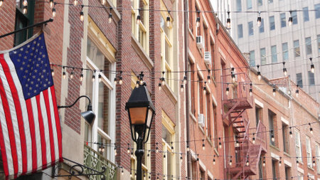 New York City building architecture. Residential house exterior. Real estate property. Typical red brick facade. Manhattan downtown financial district, Stone street, FiDi. Fire escape ladderの写真素材