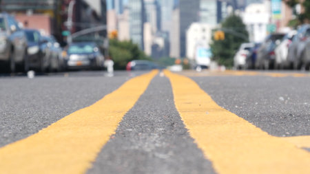 New York City skyline, Manhattan Midtown cityscape. High-rise skyscrapers from Queens, Long Island, Hunters Point, USA. Cars on street, yellow dividing line, road marking. United States architecture.の写真素材