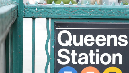 New York subway sign, Queens underground metro station. Metropolitan entrance fence, public transport exit. Long Island city street, NYC United States. Navigation text on signboard. Pedestrians peopleの写真素材