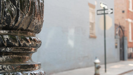 New York City oneway crossroad, Minetta street intersection one way arrow road sign. Manhattan Greenwich Village residential building architecture, NYC, United States. Blue brick wall, fire hydrant.の写真素材